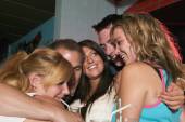 Friends drinking and hugging
